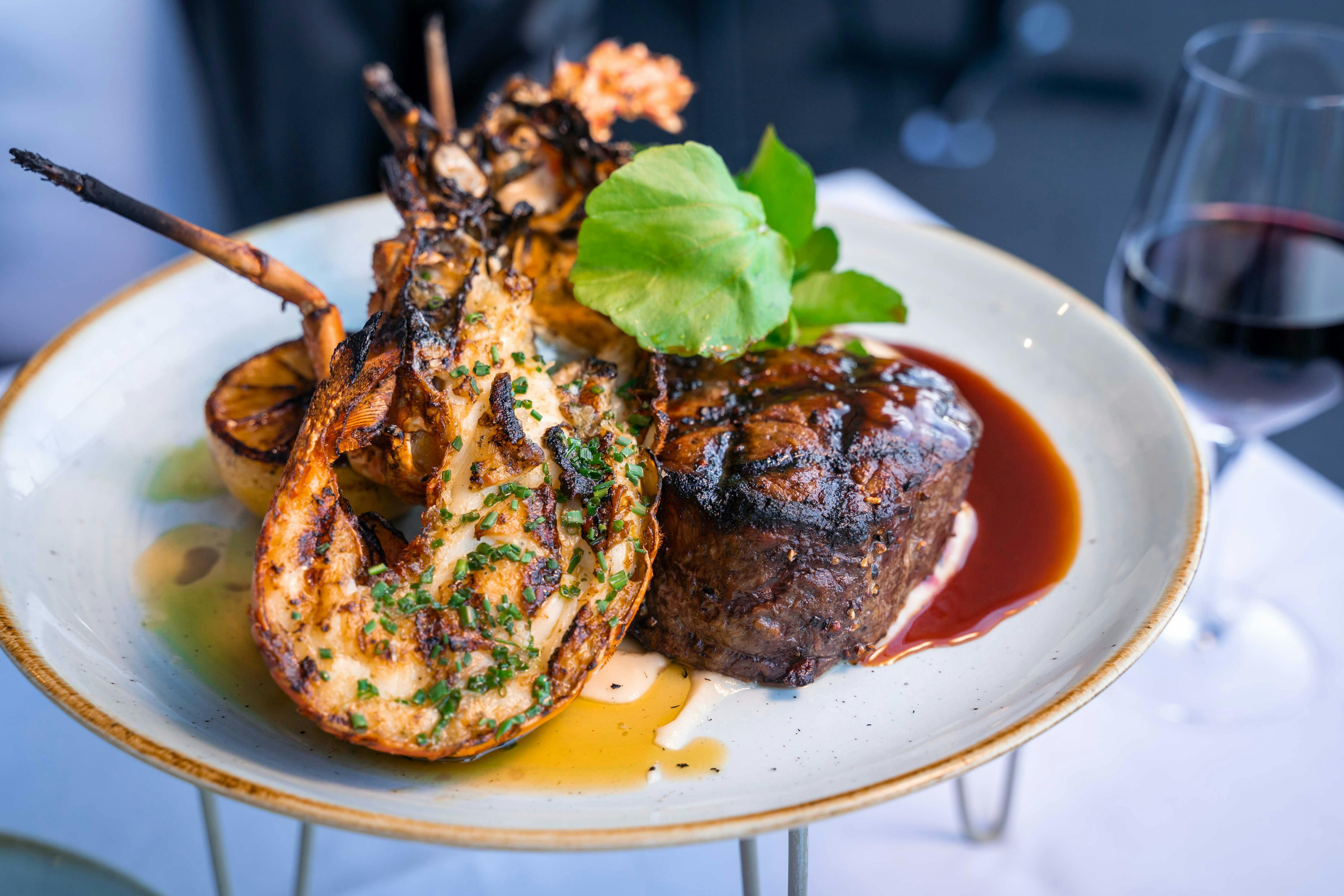 Surf and turf: 250gm beef tenderloin, garlic and herb butter roasted half lobster and red wine jus