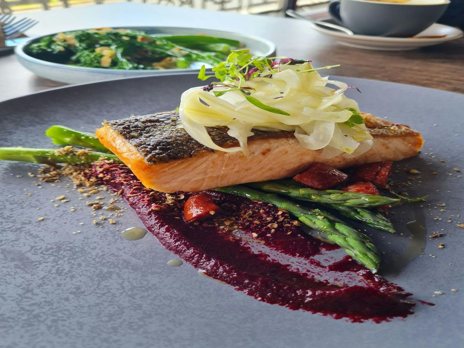 Salmon with purple and green garnish