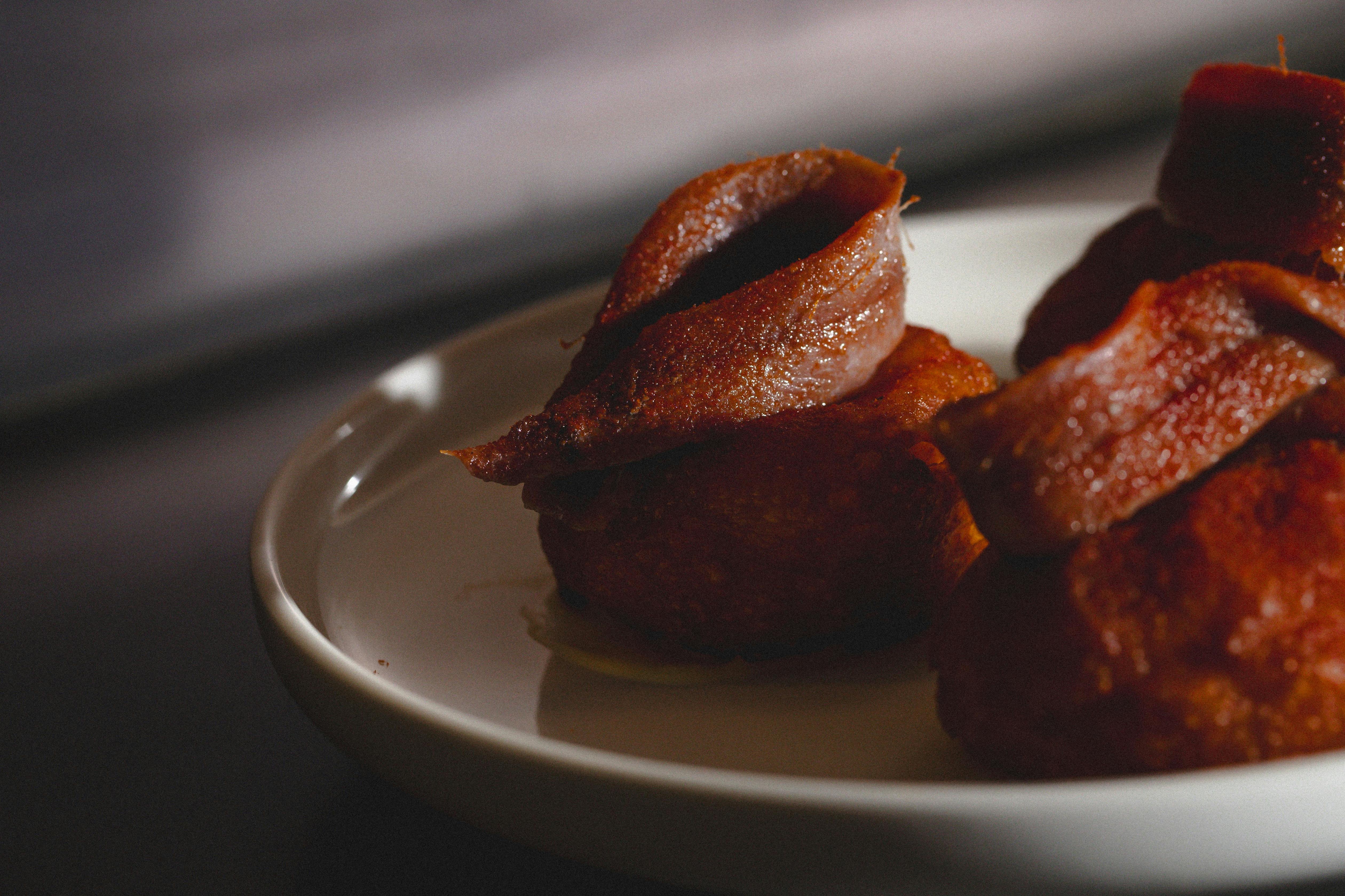 Manchego custard-filled donuts, with anchovies on top.
