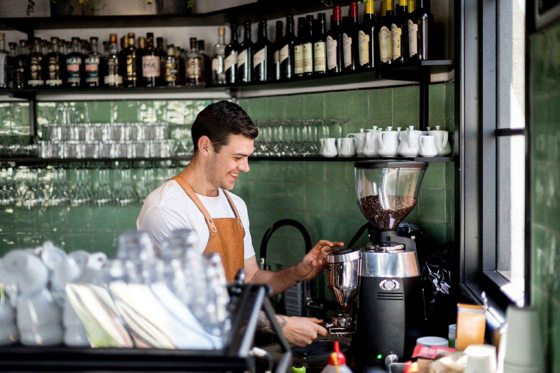 Happy barista at his job