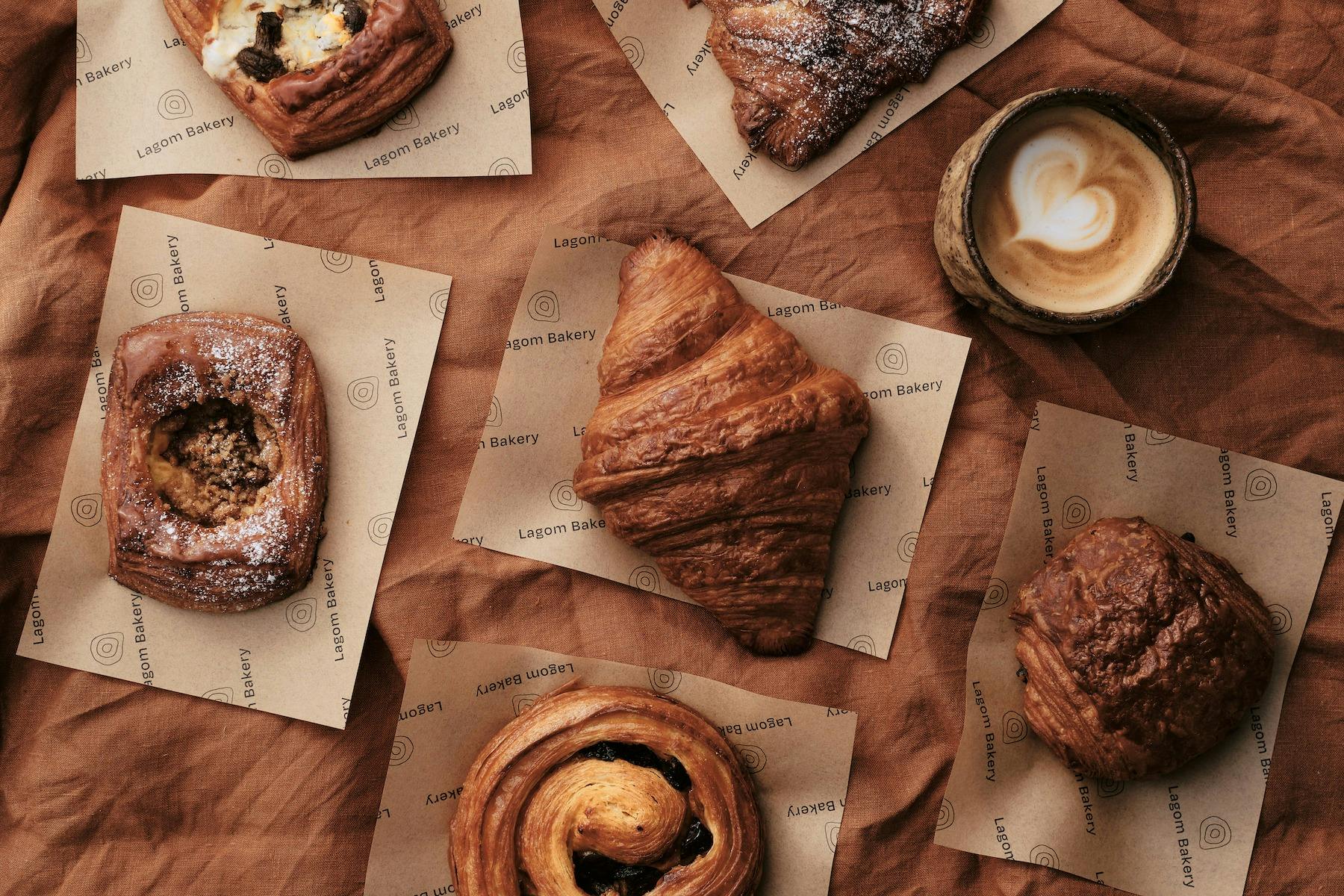 lagom bakery pastries including croissant, sweet danish, almond croissant and coffee