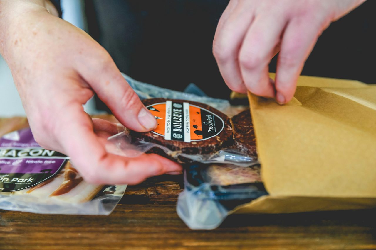 Bagging black pudding in our factory door shop
