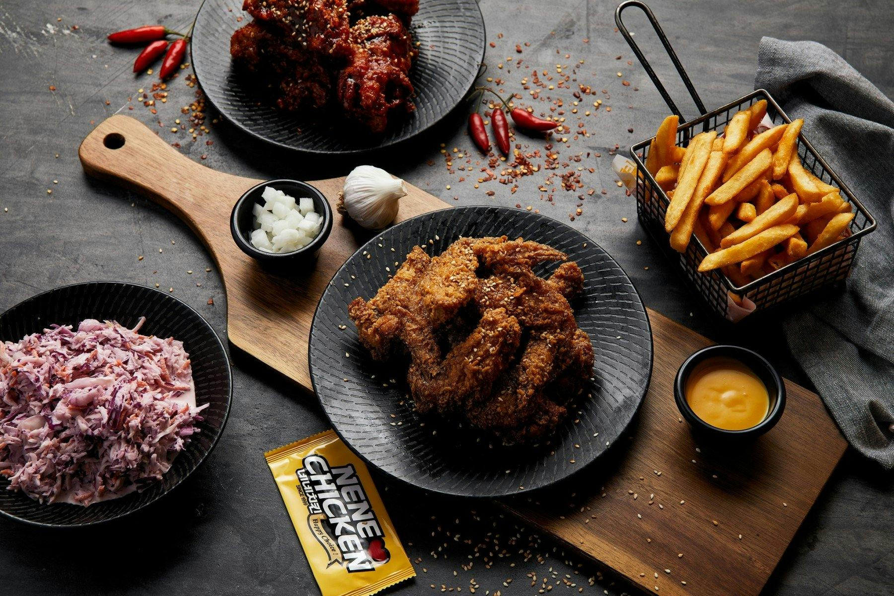 Table full of chicken and chips with garnish