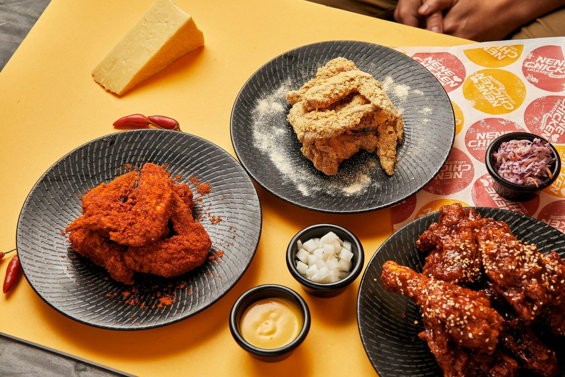 3 plates of korean fried chicken on a table