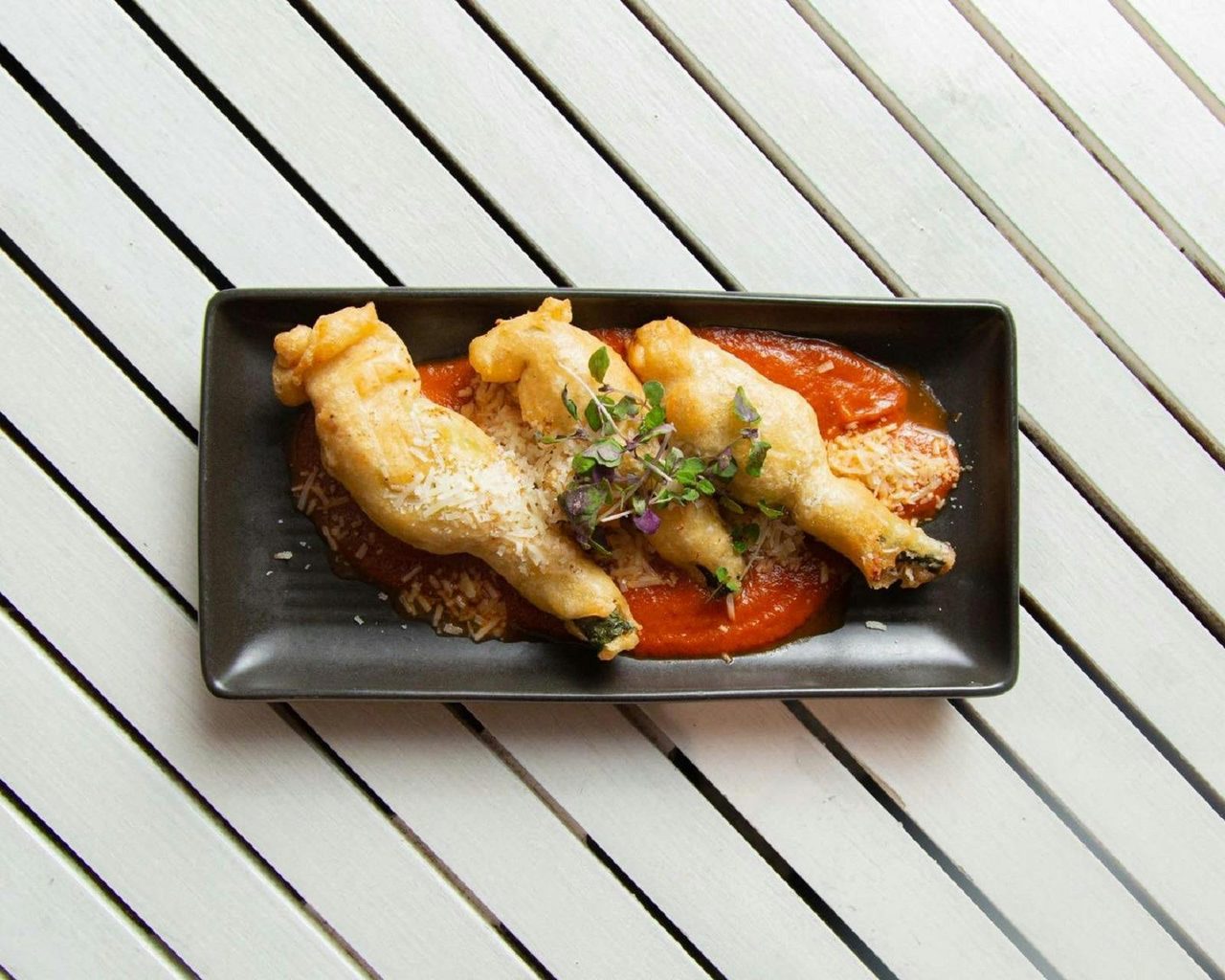 Plate of fried zucchini with sauce