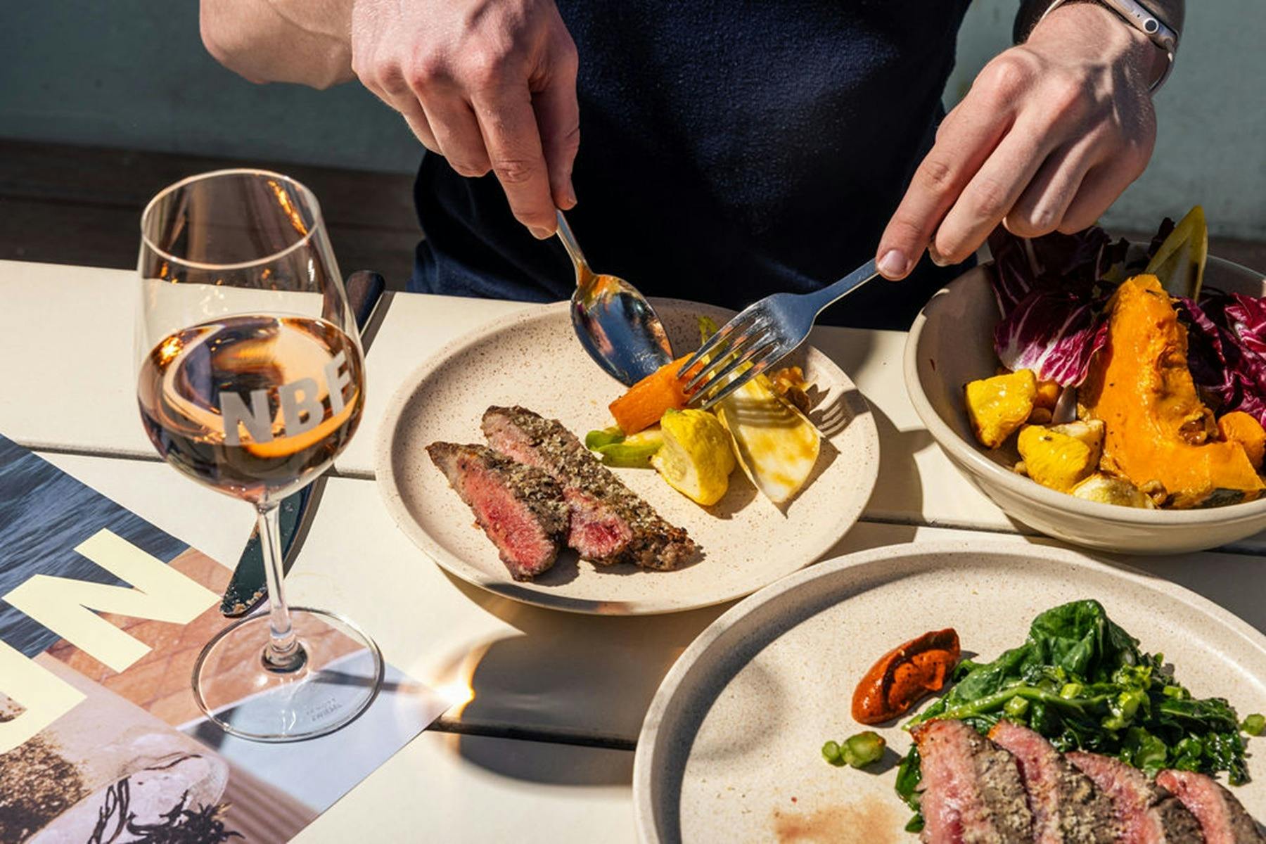 Person cutting food on plate