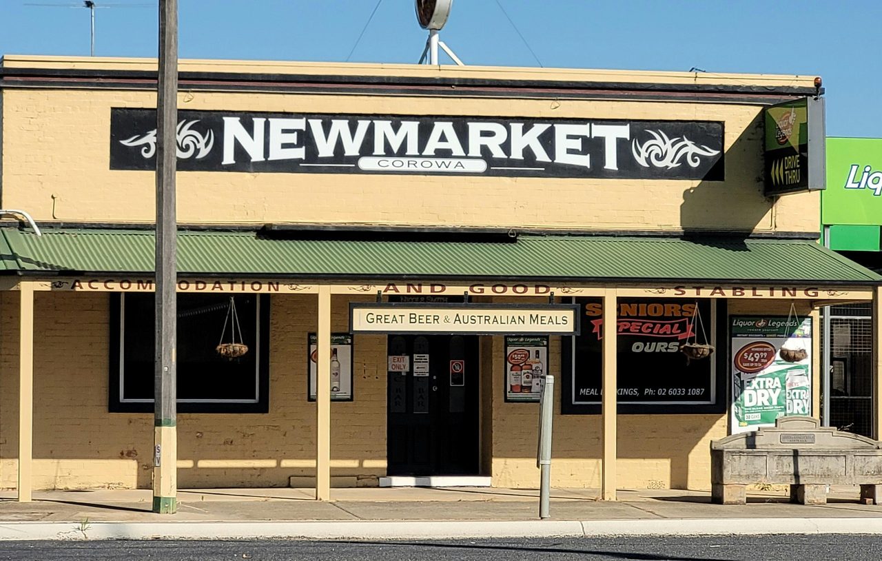 The yellow facade of Corowa's Newmarket Hotel, with the Bills horse trough in the foreground.