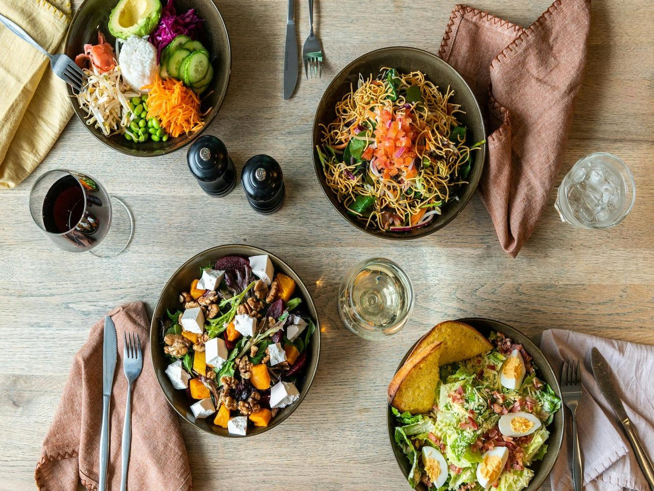 Table full of fresh salads in bowls at The Ophir
