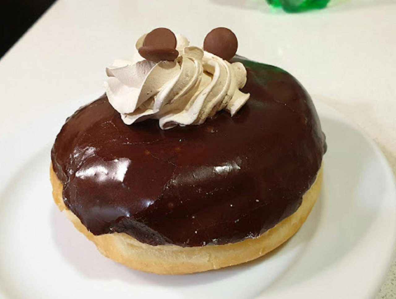 Chocolate donut with 2 chocolate sprinkles at the top