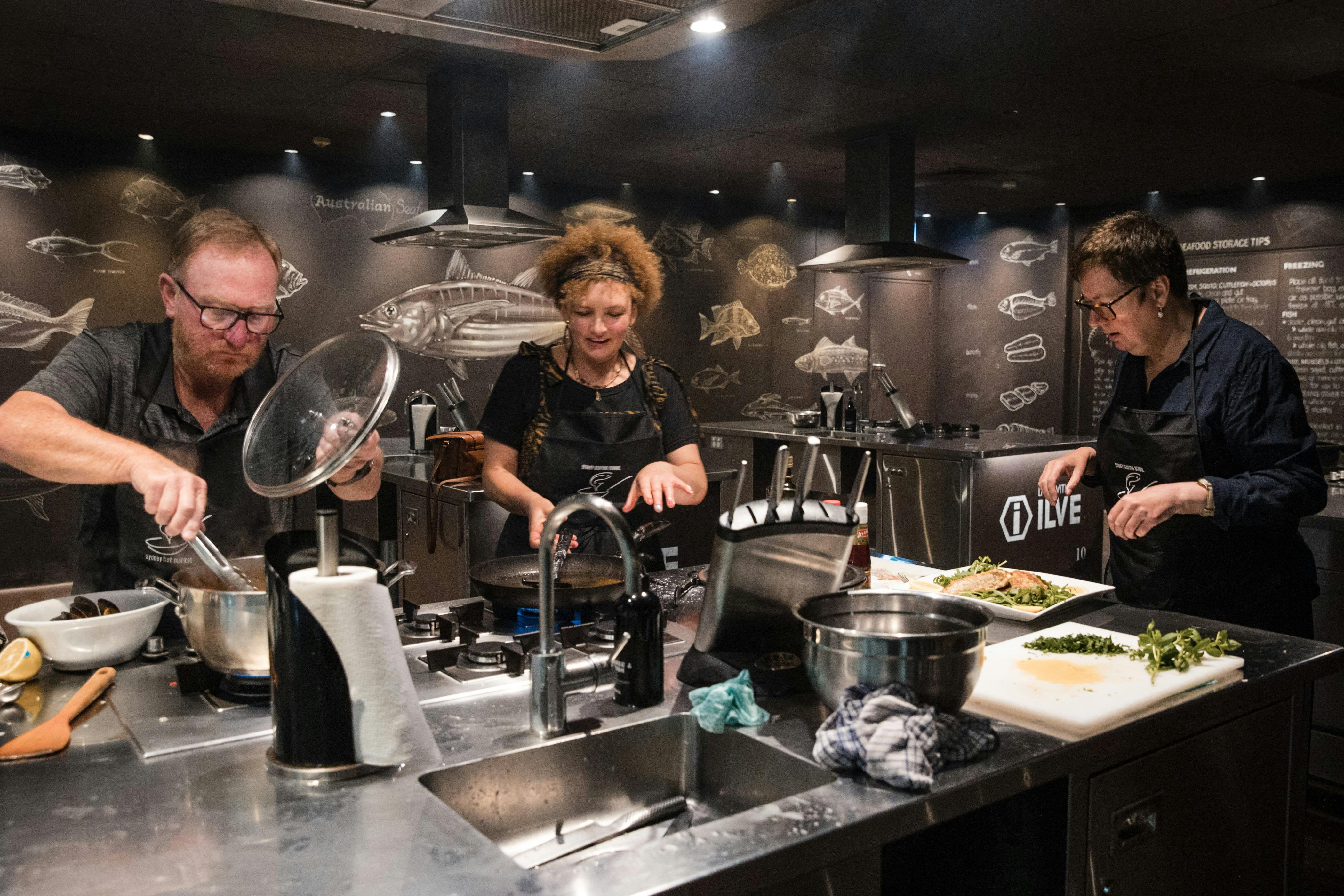 three people cooking
