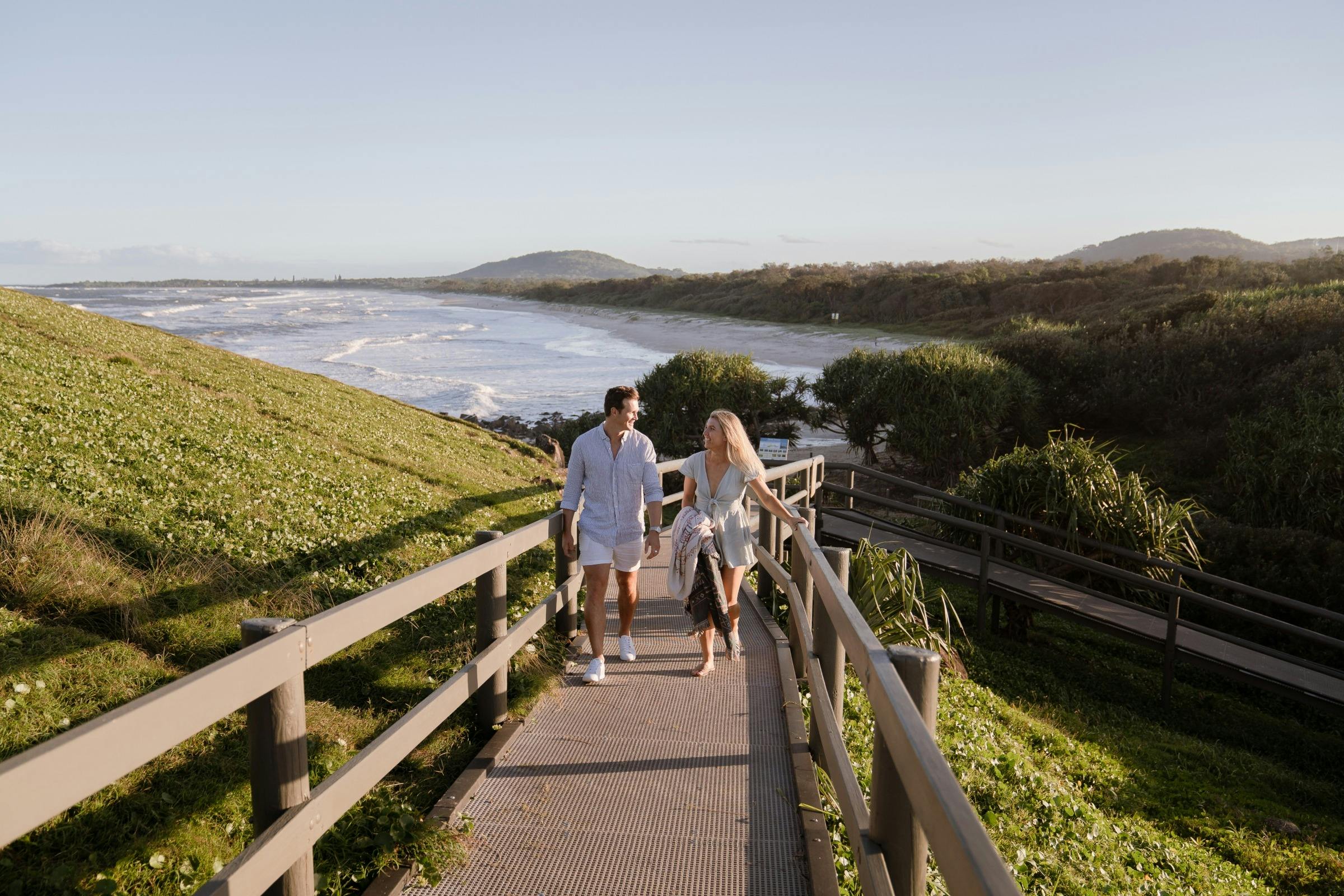 Couple walking up boardwalk