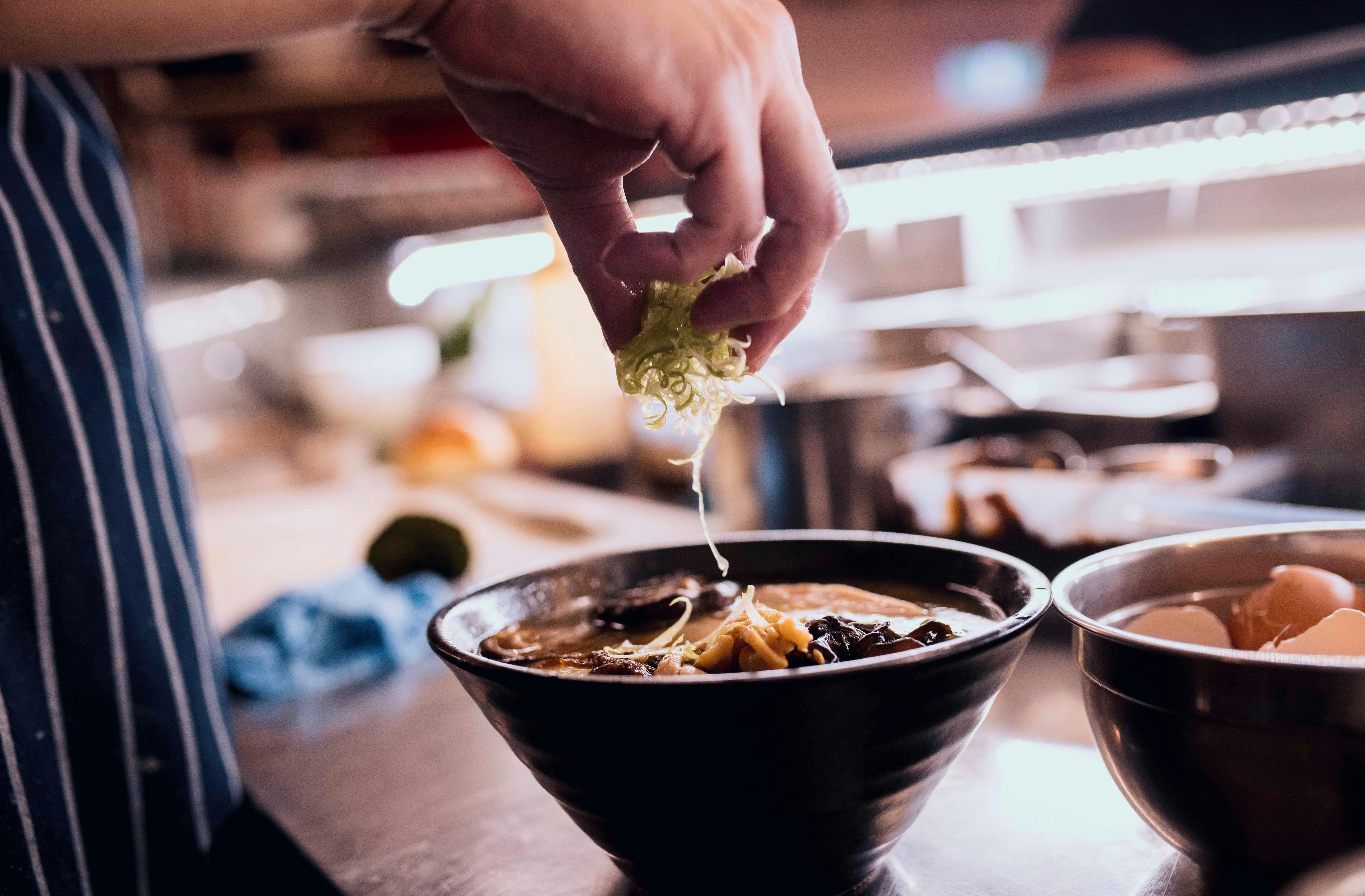 Chef making a bowl of ramen at the Rising Sun Workshop cafe