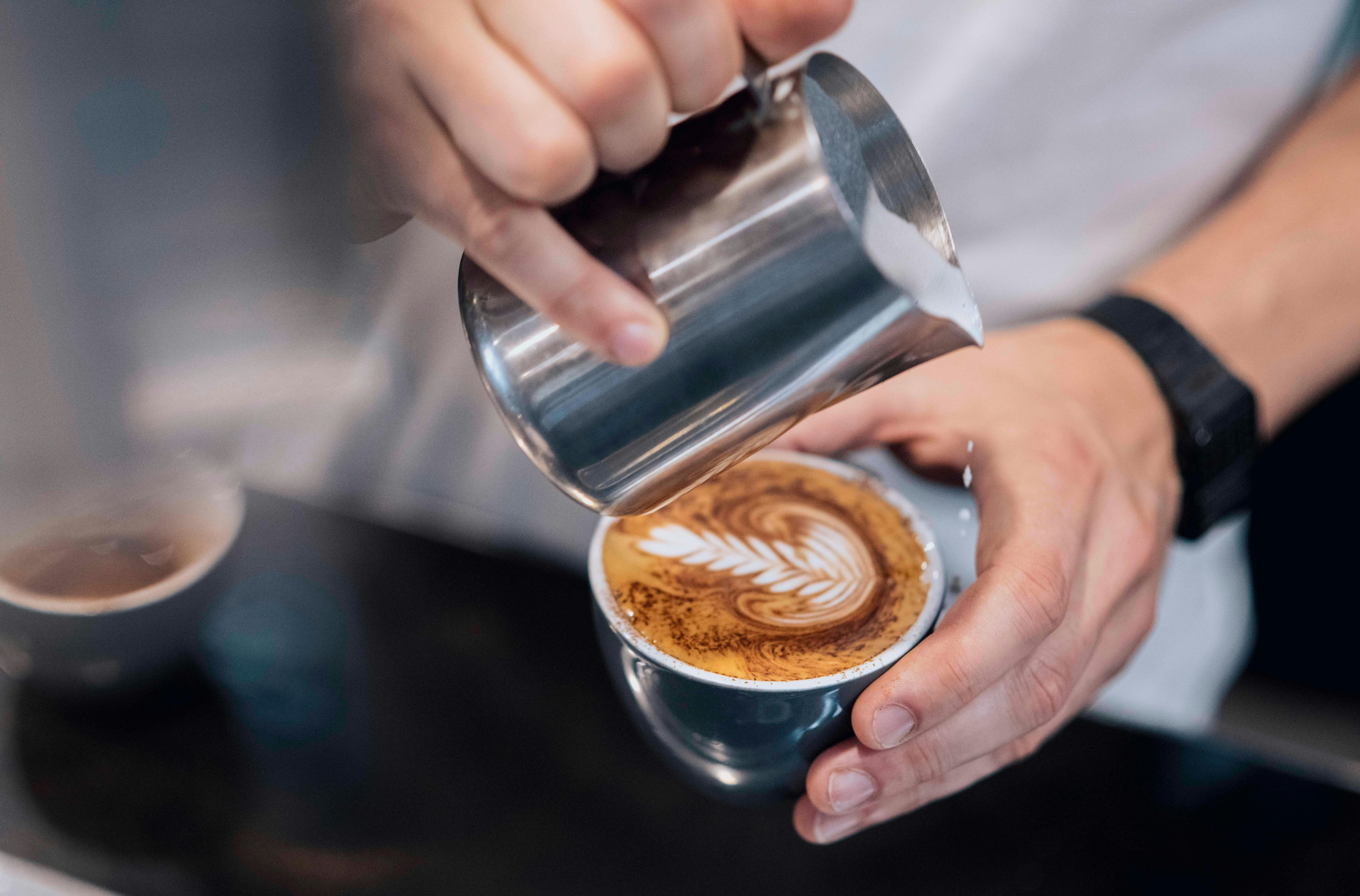 Barista making a cup of coffee at the Rising Sun Workshop cafe
