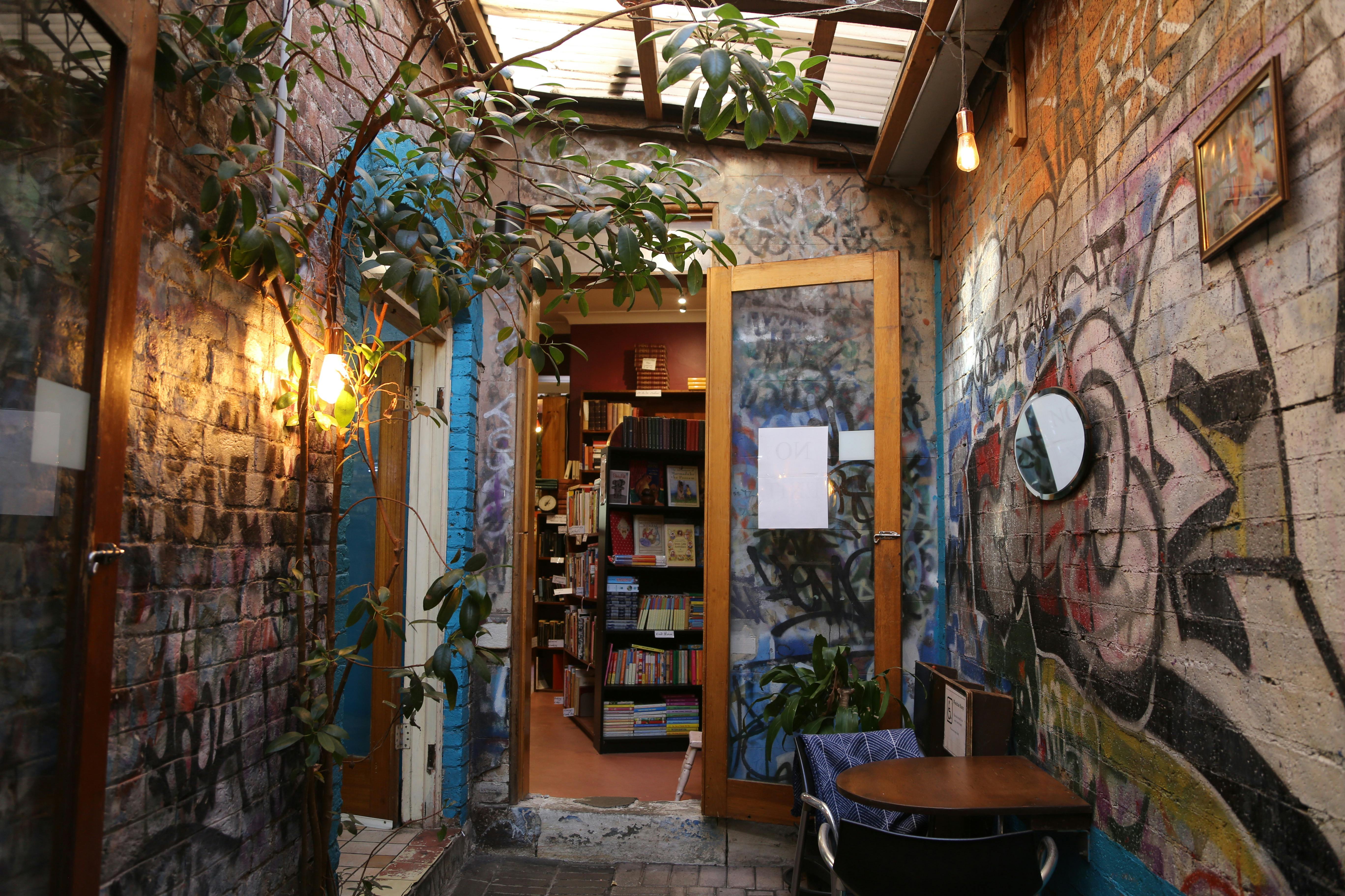 A photo of the side passage into the bookstore, colourful graffiti covering the walls