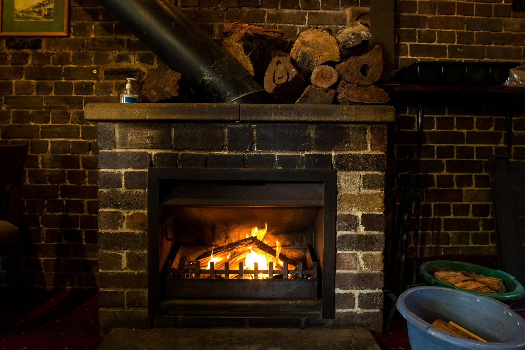 A roaring fire against a brick facade.