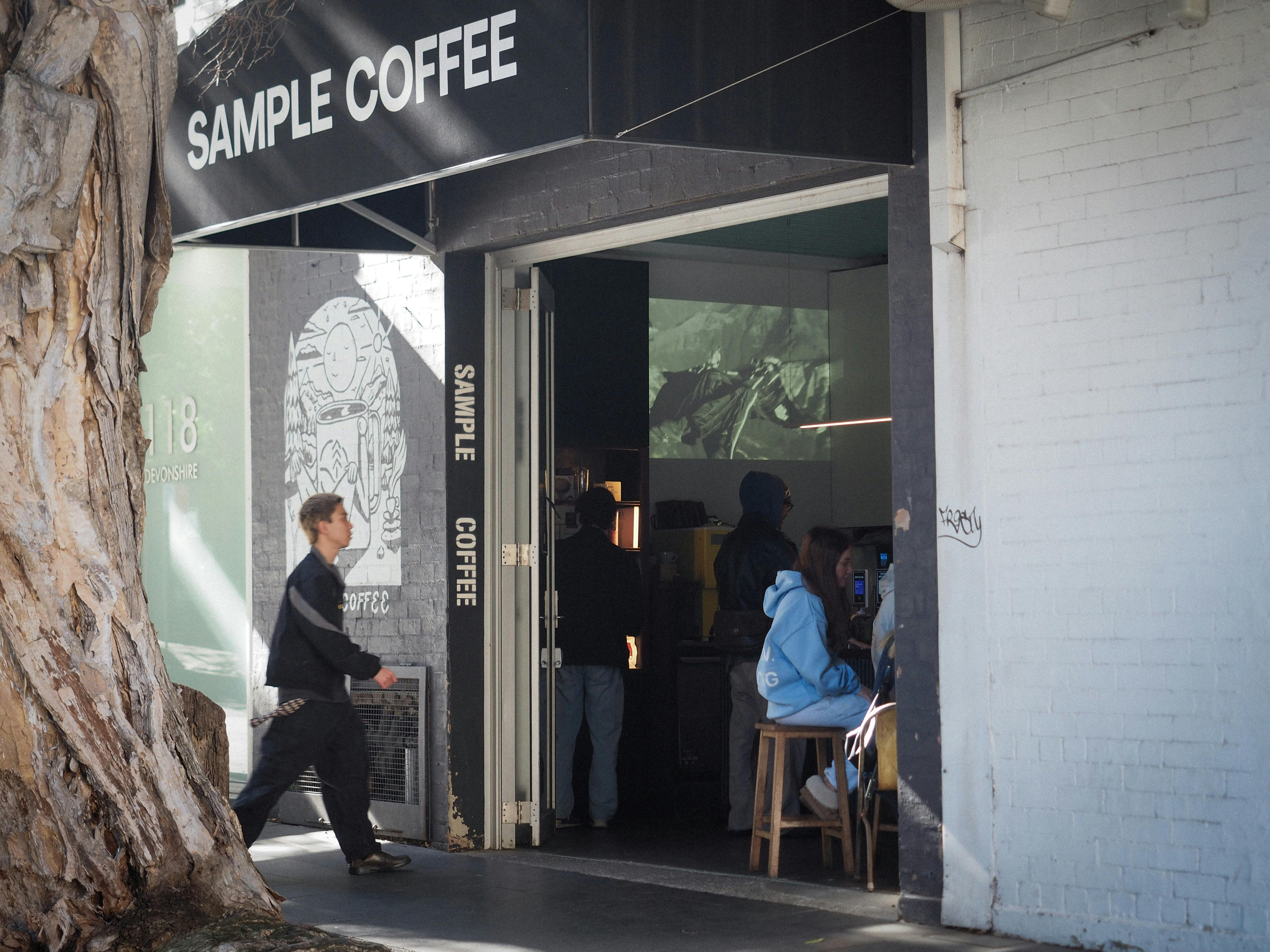 An outdoor shot of Sample Coffee Surry Hills entry.